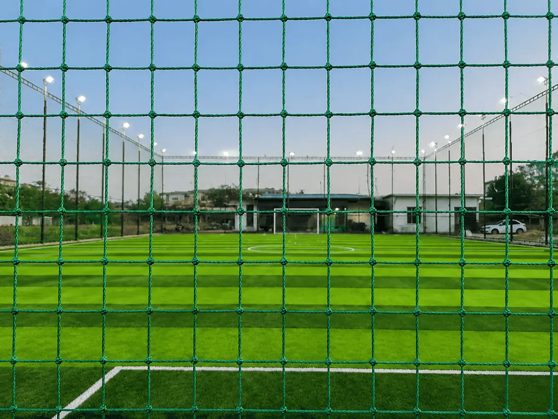 Football pitch seen through Garware perimeter netting